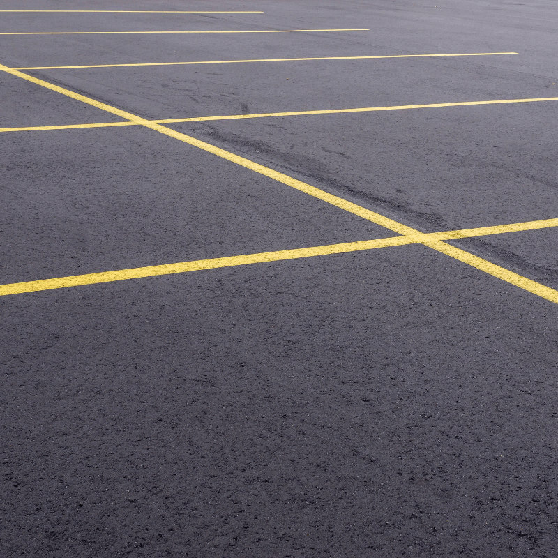 Untitled design (46) An empty parking lot in PA features freshly painted yellow lines on its smooth asphalt surface, all thanks to a reliable paving company.