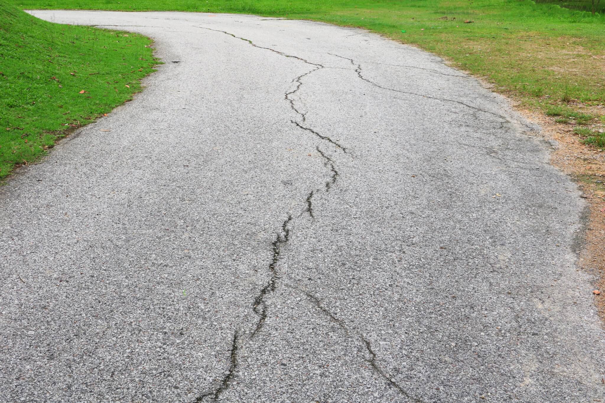 Lifecycle of Asphalt asphalt road cracked. street in public park Lifecycle of Asphalt